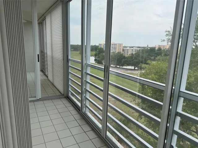 Separate glass and screen enclosed lanai for primary bedroom. There's a sliding door that separates the primary bedroom lanai from the one off of the living room.