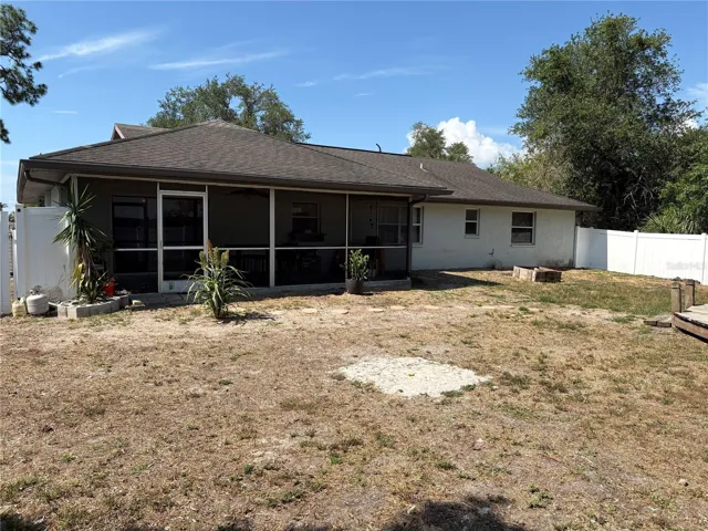 VIEW FROM RIGHT BACK CORNER OF BACKYARD TO THE BACK OF THE HOME