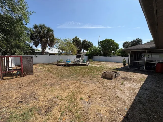 VIEW FROM LEFT BACK SIDE OF HOUSE INTO BACKYARD
