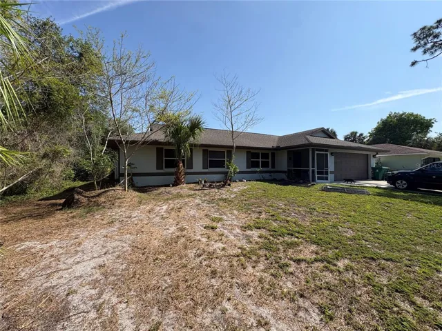 VIEW FROM RIGHT BACK CORNER OF YARD TO BACK OF HOME