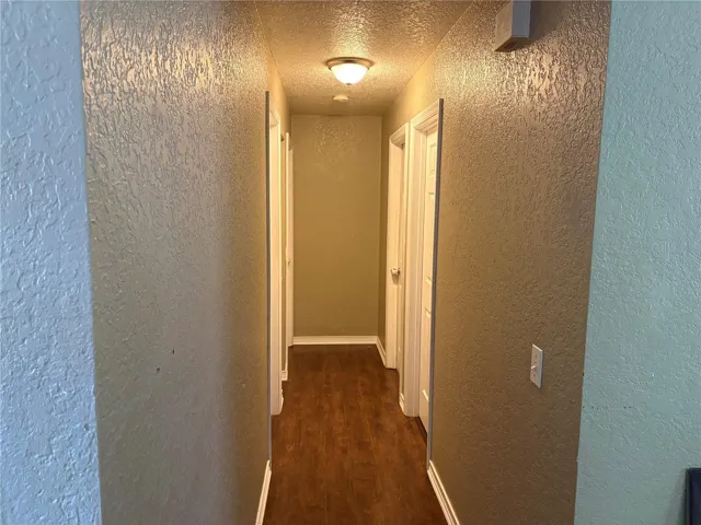 VIEW FROM LIVING ROOM DOWN THE HALLWAY TO BEDROOMS