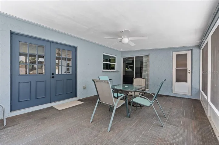 Enclosed rear porch with access to the dining room, family room and bathroom.  Also features a large window that can double as a pass through.