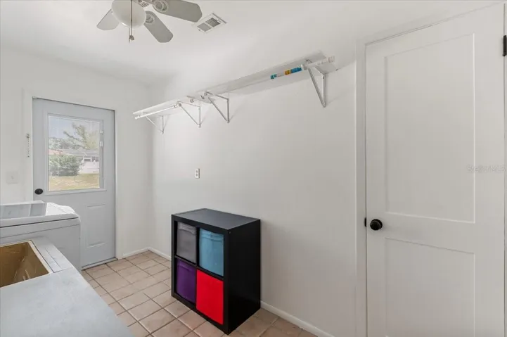 Laundry room with large storage closet.