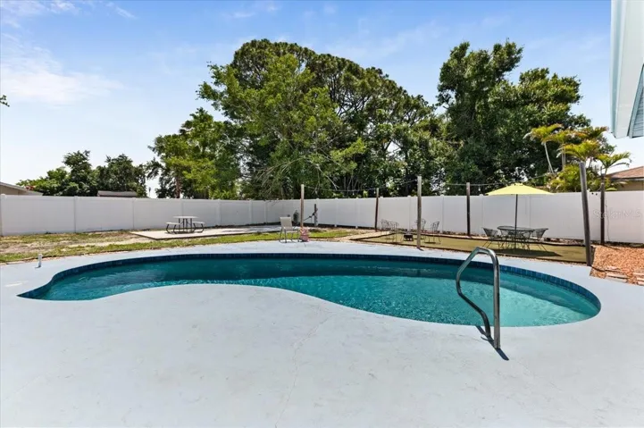 Artificial turf makes a great spot for hanging out or a playground space.  Concrete pad in the back was used previously for a basketball play area.