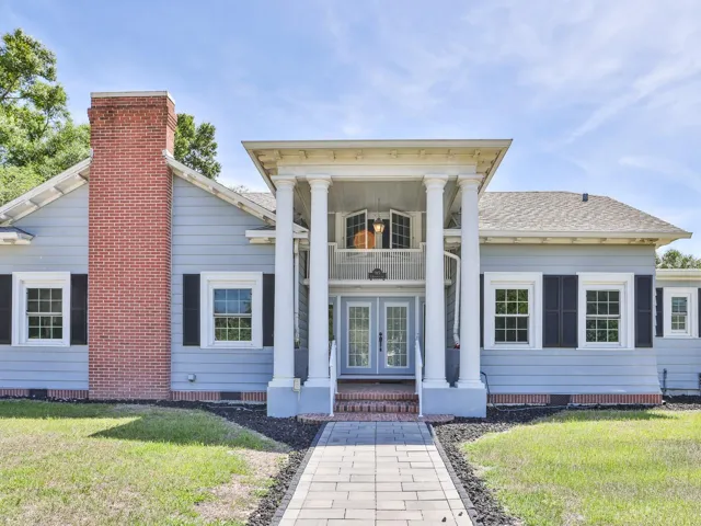 Front of the home with a paver side walk.
