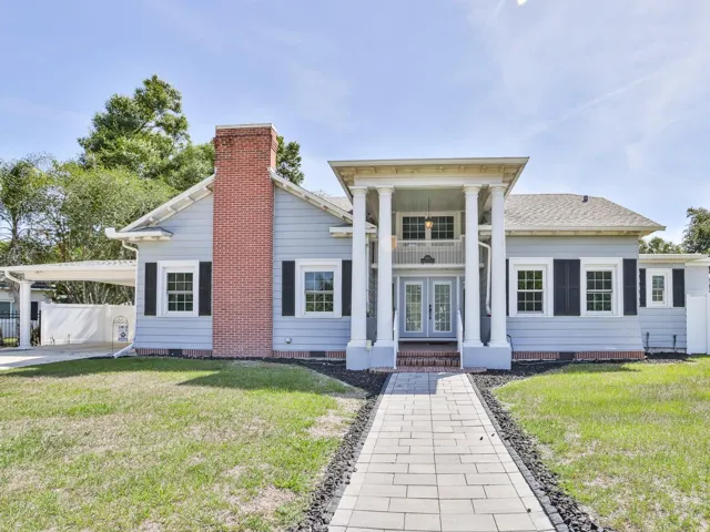 Front of the home with a paver side walk.