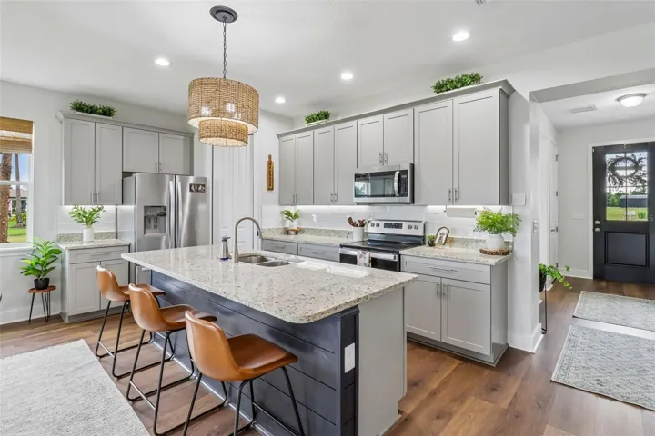 Soft close cabinetry, large island with seating, new stove, corner pantry