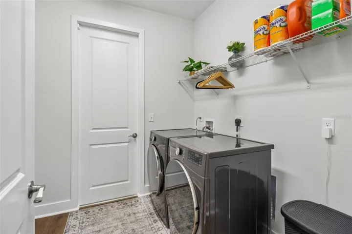 Laundry room / mud room with hanging for bags etc and new appliances that convey