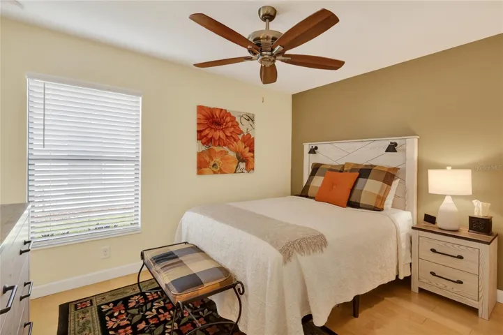 Bedroom 2 with wood flooring, ceiling fan