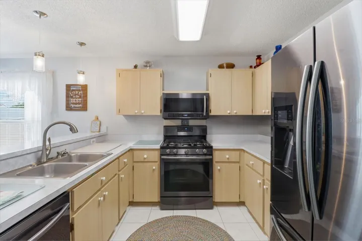 Kitchen w/ Tile Flooring, Slate Appliances, Gas Range, Raised Breakfast Bar & Pantry Closet