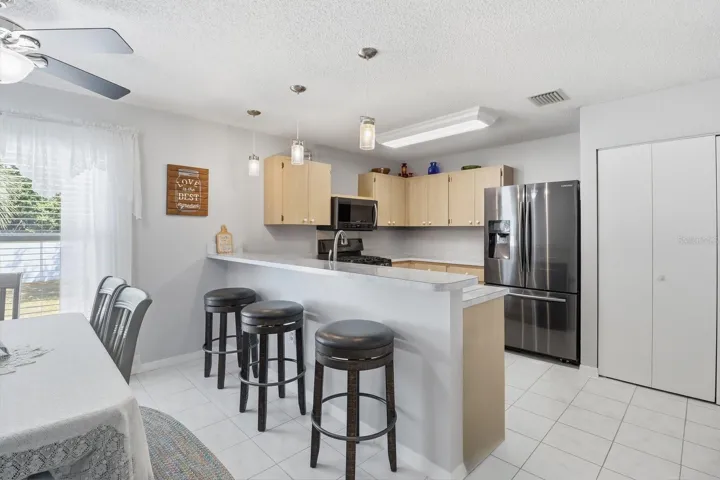 Kitchen w/ Tile Flooring, Slate Appliances, Gas Range, Raised Breakfast Bar & Pantry Closet