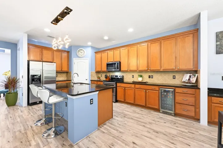 Inside, WOOD-LOOK TILE FLOORING flows throughout the home, complemented by fresh neutral paint, and light-filled living spaces that feel warm, open, and MOVE-IN READY.