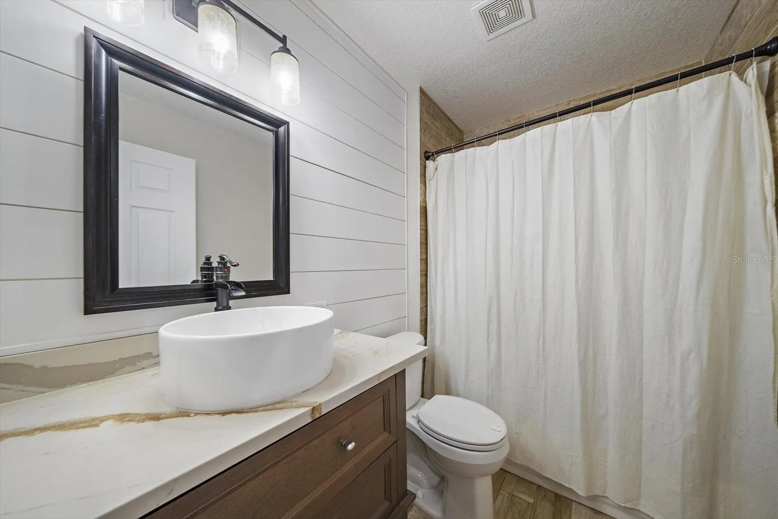 Guest bathroom - tub/shower combo with new shiplap and paint