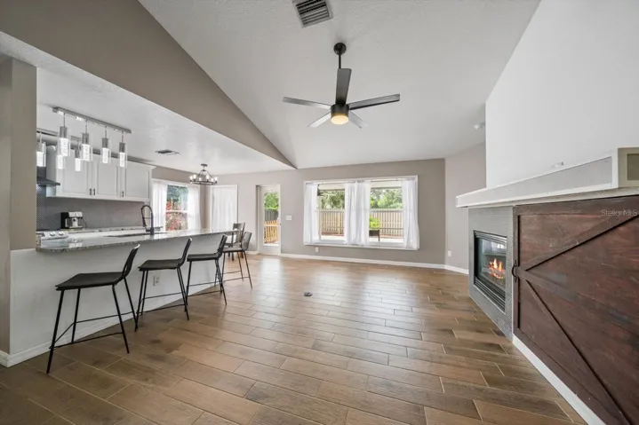 Living room with breakfast bar seating in the kitchen