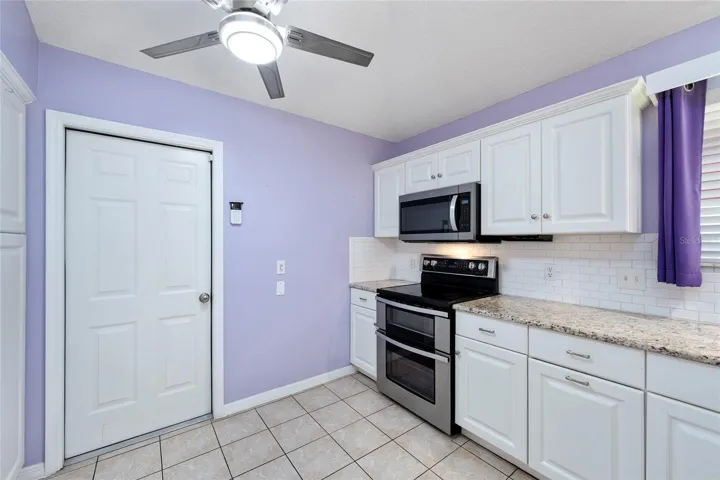 KITCHEN - Garage access door (L). Note SimpliSafe Security System to R of garage access door