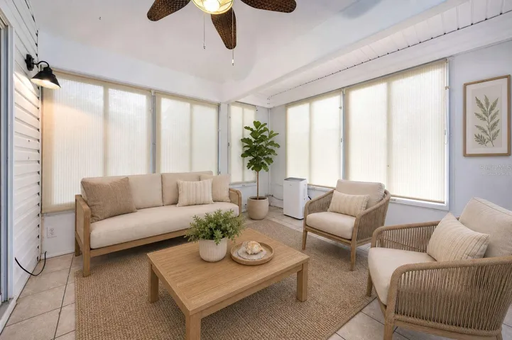 View of ENCLOSED LANAI from SLIDING GLASS DOORS to LIVING ROOM - Virtually Staged