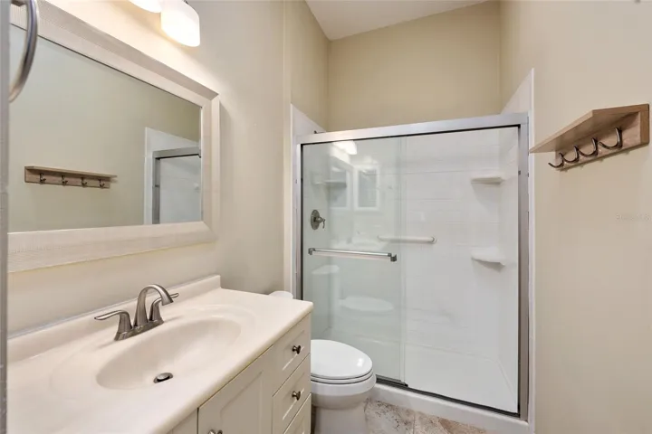 Updated BATHROOM #2 with COMFORT HEIGHT TOILET and shower renovation with TILE SURROUND & SLIDING GLASS DOORS