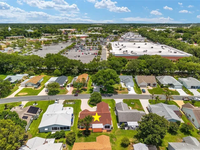 AERIAL - looking East  toward the nearby 441 commercial corridor, showcasing the exceptional everyday convenience of this location. The shopping center visible to the right is anchored by Target, with Best Buy and HomeSense located just beyond.
