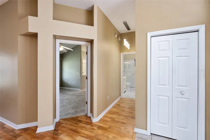 Entrance to PRIMARY BEDROOM - ARCHED ENTRYWAY with plant shelf above