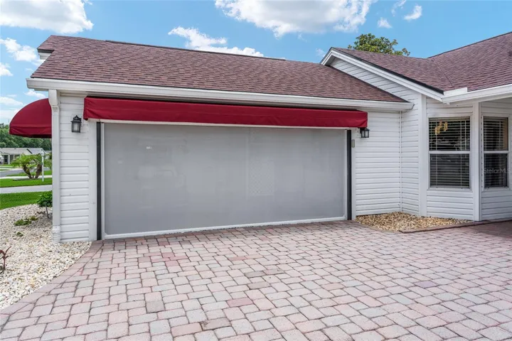 2 CAR GARAGE - Note the Motorized Electric Screen and Awning