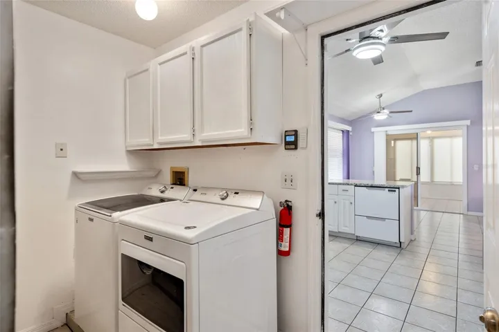LAUNDRY AREA on L (in garage). Garage access door on R leads to KITCHEN.