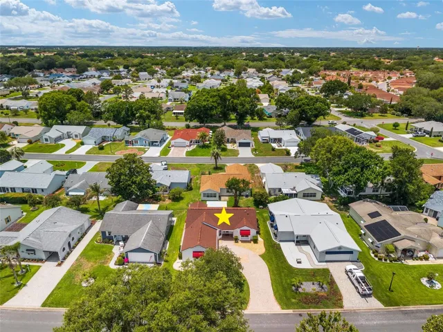 AERIAL - looking West from Cortez Avenue, with Vista Place just one street behind the home and Rio Grande beyond, providing easy access toward Spanish Springs, approximately 6 minutes away, and Lake Sumter Landing, approximately 11 minutes away via Morse Boulevard.