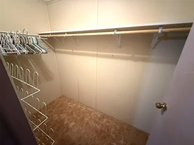 Primary bedroom walk-in closet