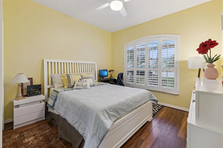 Bedroom #3 features plantation shutters and ceiling fan