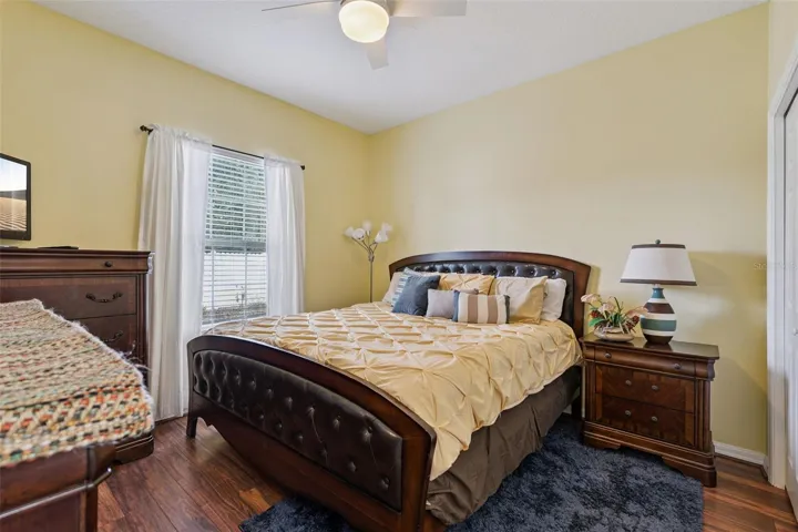 Bedroom #2 with wood laminate and ceiling fan
