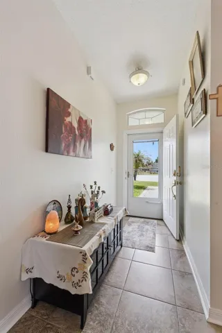 Foyer features tile flooring, transom window and smart lock