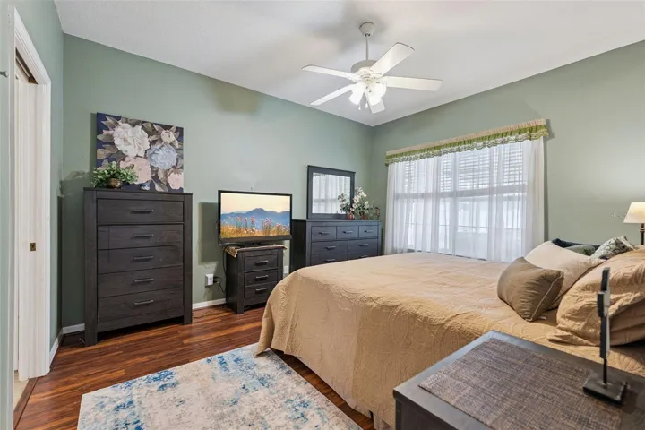 Primary Bedroom features a walk-in closet and views of the backyard