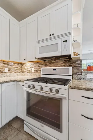 Gas Range, tile back splash and granite countertops