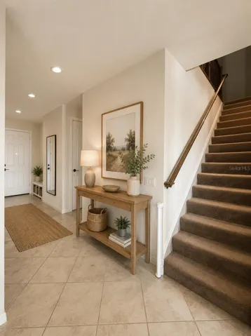 Grand Hallway with Elegant Staircase Leading Upstairs