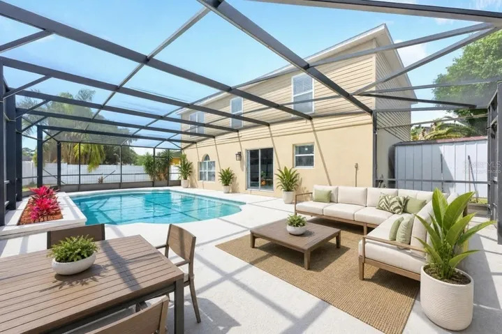 Relax and unwind poolside, screened for year-round comfort! Virtually Staged.