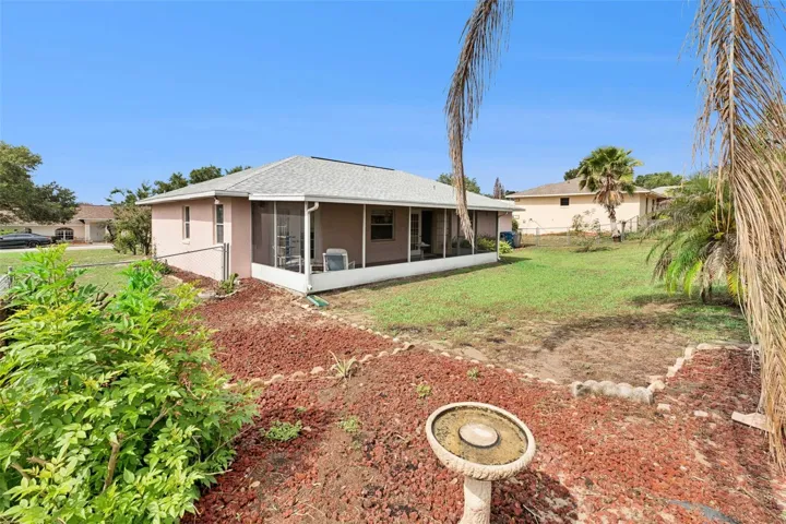 Large fenced in yard with irrigation system