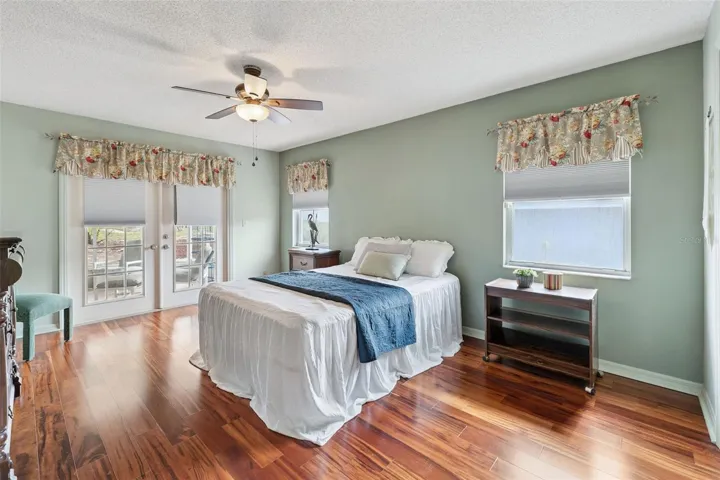 Generously sized Primary Bedroom features a walk-in closet & French doors leading into the screened-in lanai