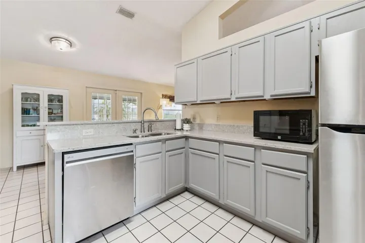 Gooseneck faucet and updated stainless dishwasher and refrigerator