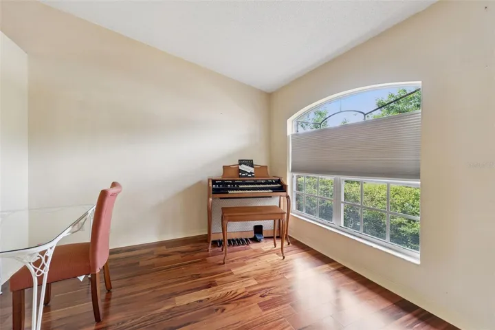 Den/Office features a large arched window