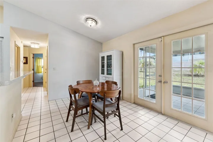 Lovely breakfast nook features French doors leading to the screened lanai