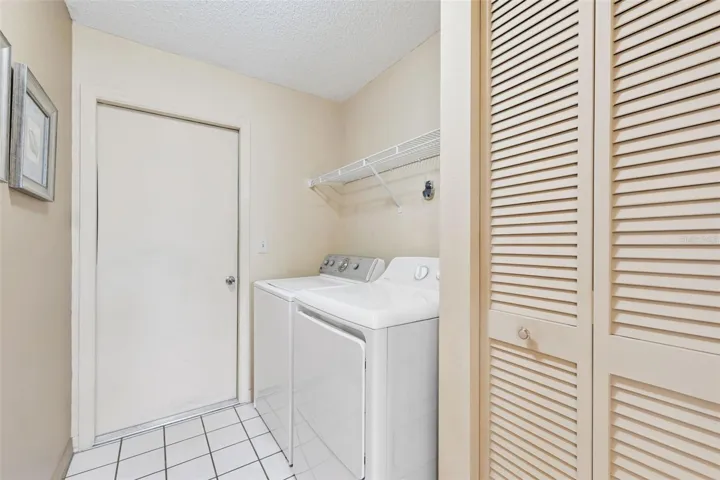 Laundry Room features washer, dryer and linen closet