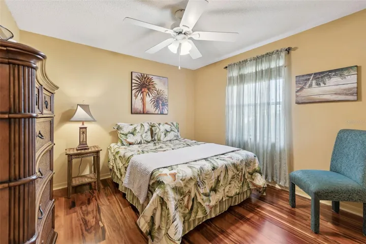 Bedroom #2 with tigerwood flooring and ceiling fan