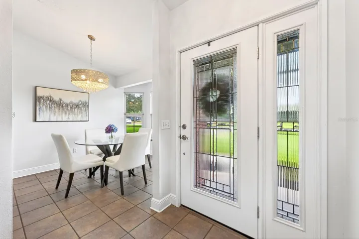 Step through the elegant ETCHED-GLASS FRONT DOOR with matching sidelight and immediately notice the STUNNING CHANDELIER (2021).