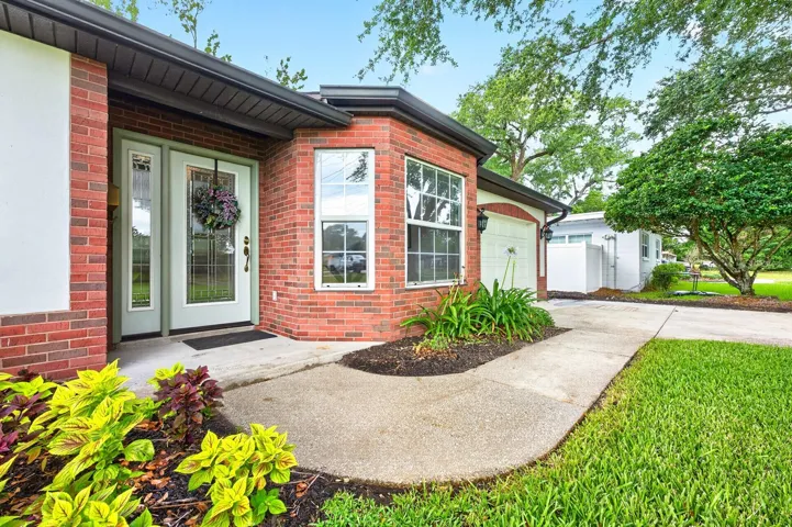 Situated on an OVERSIZED LOT with NO HOA, this single-story home offers WONDERFUL CURB APPEAL with its gorgeous REFRESHED LANDSCAPING (2026) and classic brick-front exterior.