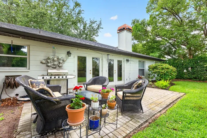 A brick patio creates the perfect outdoor gathering space.