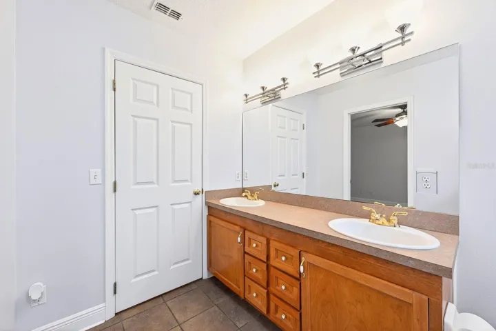 The Primary EN SUITE BATH is complete with dual sinks and a NEWLY UPDATED JETTED TUB WITH SHOWER (2026).
