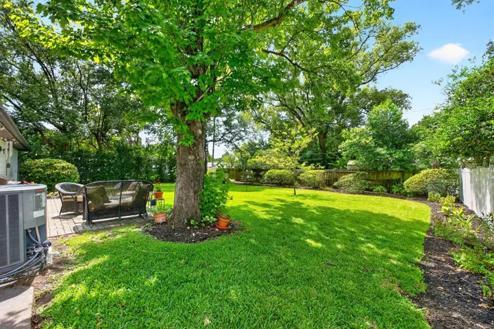 A brick patio creates the perfect outdoor gathering space.