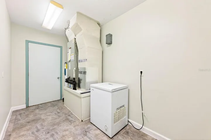 An additional UTILITY/STORAGE ROOM behind the 2-car garage offers even more functionality with NEW FLOORING, FRESH PAINT (2026), and an included freezer.