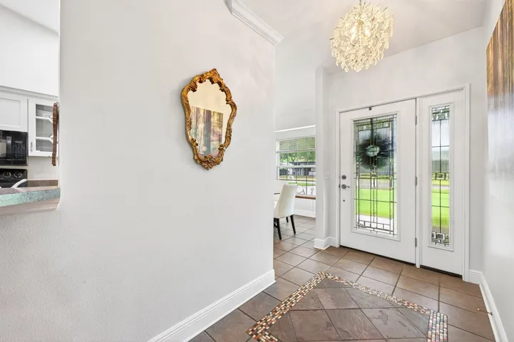 Step through the elegant ETCHED-GLASS FRONT DOOR with matching sidelight and immediately notice the STUNNING CHANDELIER (2021).