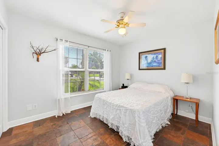 Two additional bedrooms provide flexibility for family, guests, or a home office—one featuring distinctive SLATE FLOORING (2018) and the other WARM WOOD FLOORING—both conveniently located near the second full bath. Bedroom 2