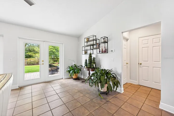 Two sets of GLASS FRENCH DOORS fill the space with NATURAL LIGHT and open to the backyard patio area.